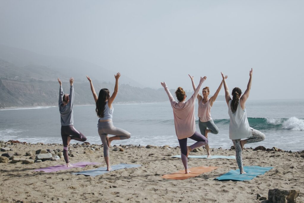 Yoga Tai Chi five woman standing on seashore