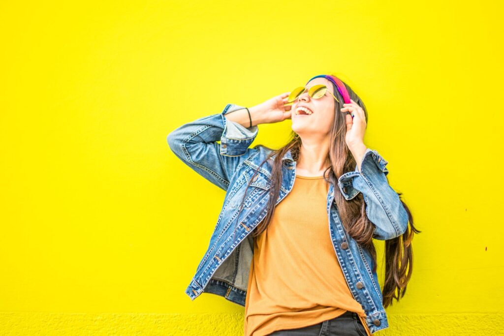 feliz, melhor estado emocinal, Smiling Woman Looking Upright Standing Against Yellow Wall