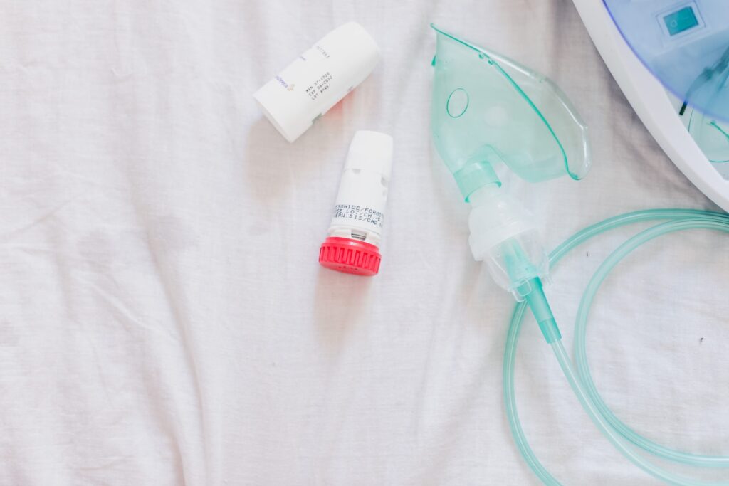 ASMA a close up of a bed with a device and a bottle